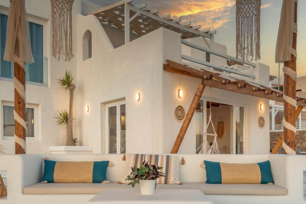a living room with a couch in front of a building at Silia Dream View in Houlakia