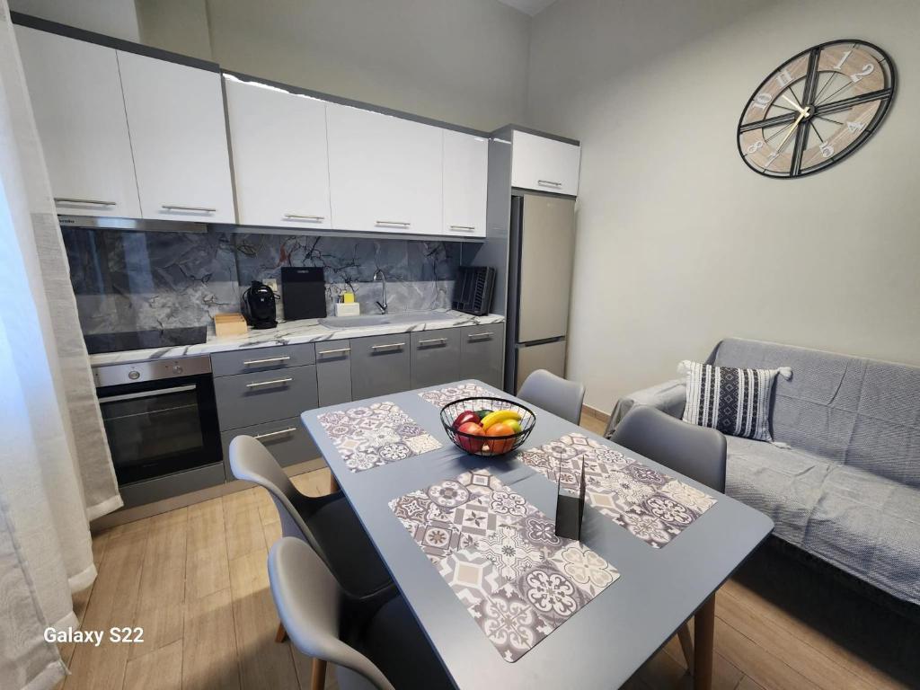 a kitchen with a table with a bowl of fruit on it at Orange Grove in Plomari
