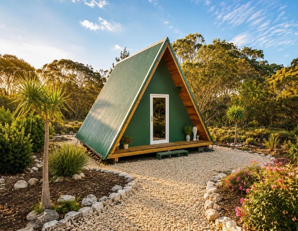 a tiny house in a garden with a green roof at Kangaroo Island A-Frame Off-Grid Escape in Pelican Lagoon