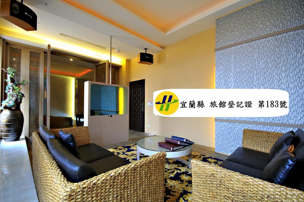 a living room with two couches and a table at Dubai Motel in Yilan City
