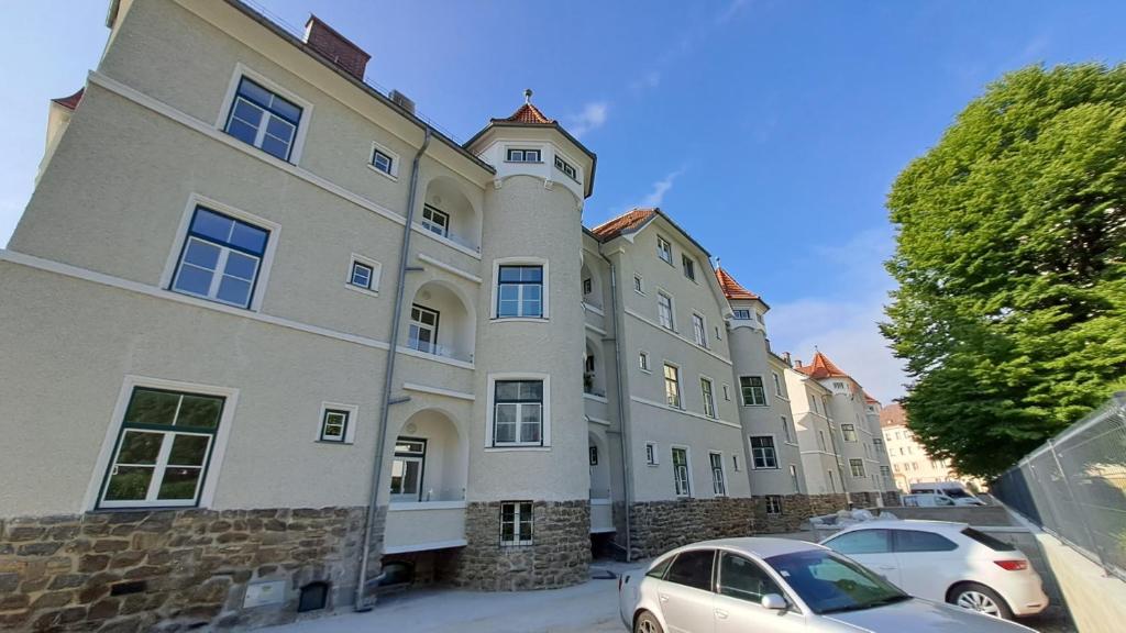 a large building with cars parked in front of it at Krems am Campus in Krems an der Donau
