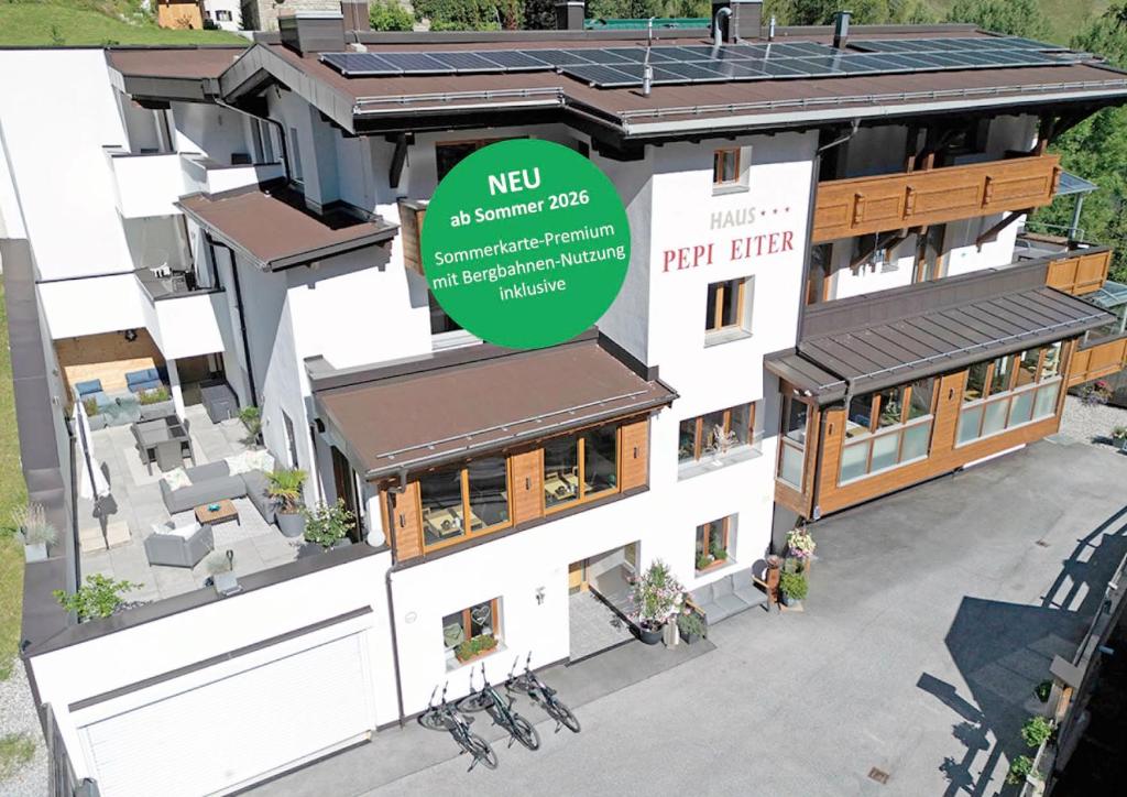 a rendering of a new apartment building with a green logo at Quality Hosts Arlberg - Haus Pepi Eiter - inklusive Sommer-Karte Premium in Sankt Anton am Arlberg