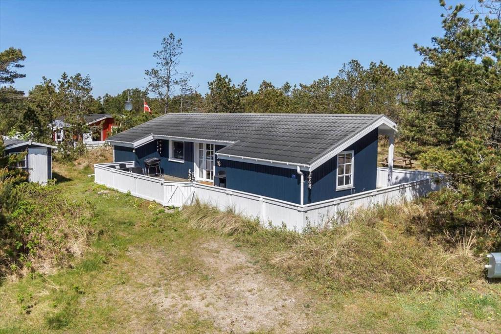 a blue house sitting on top of a hill at 329-Thisted-Sandtornvej-21 in Thisted