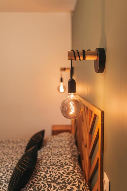 a bedroom with a bed with a lamp on it at Chez Gabriel et Sophie in Pérouges