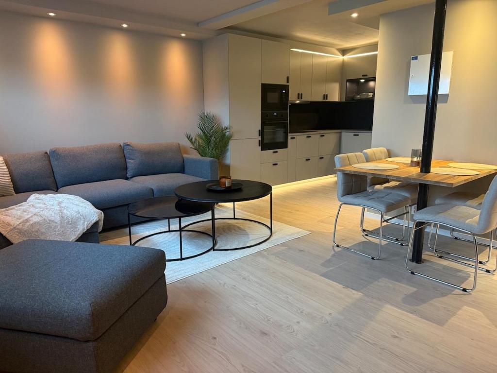 a living room with a couch and a table at Villa Nyheim in Florø
