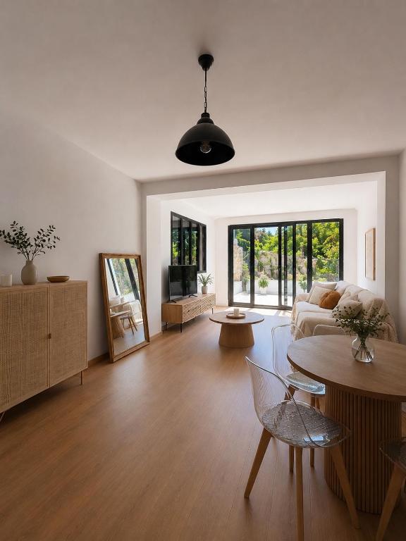 a living room with a couch and a table at Maison Plumeria in Triel-sur-Seine