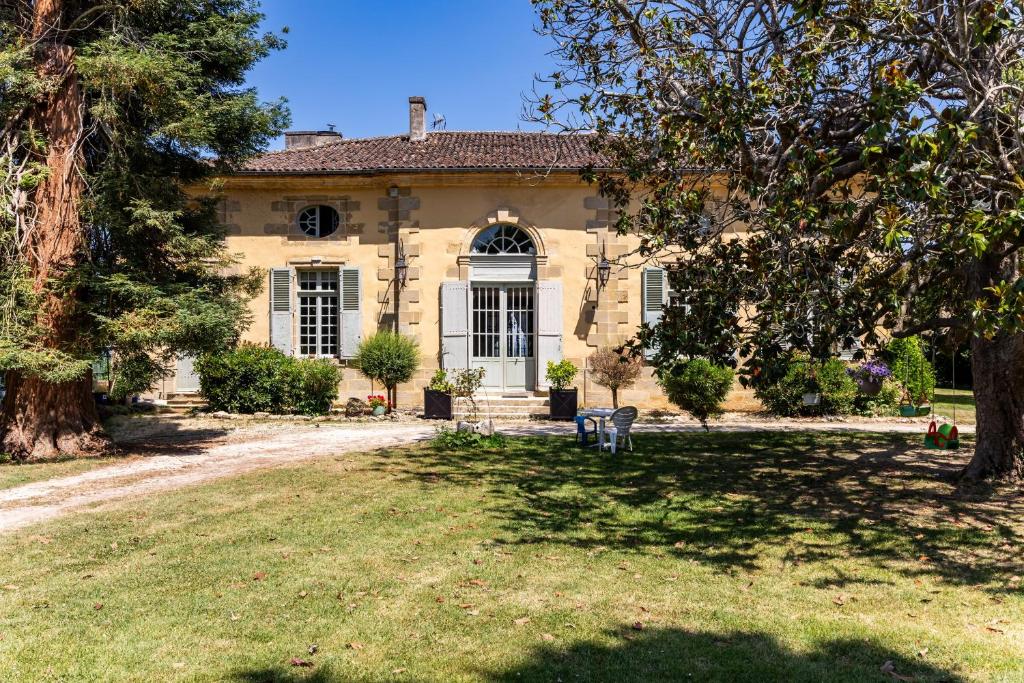 a large house with a yard in front of it at Château Puybarban in Puybarban