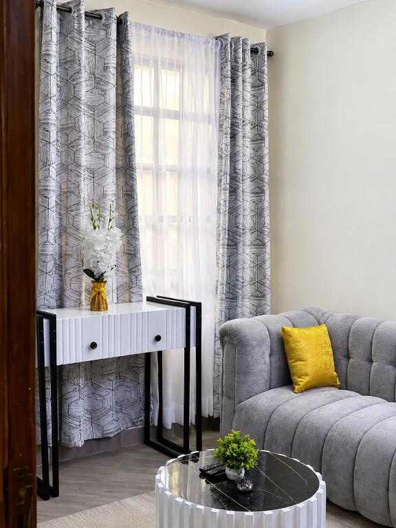 a living room with a couch and a table at One bedroom in Narok