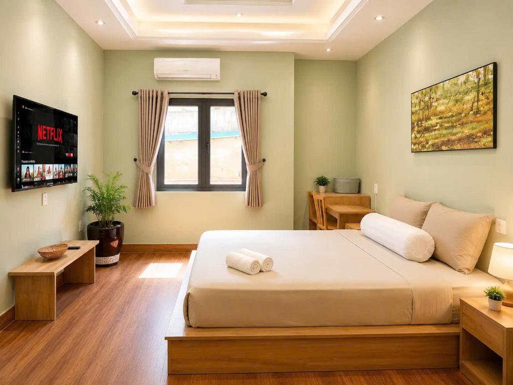 a bedroom with a large bed and a window at Ben Thanh Hideaway - A Cozi Stay in Ho Chi Minh City