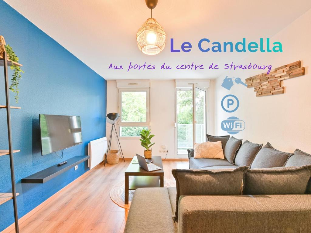 a living room with a couch and a tv at Candella in Strasbourg
