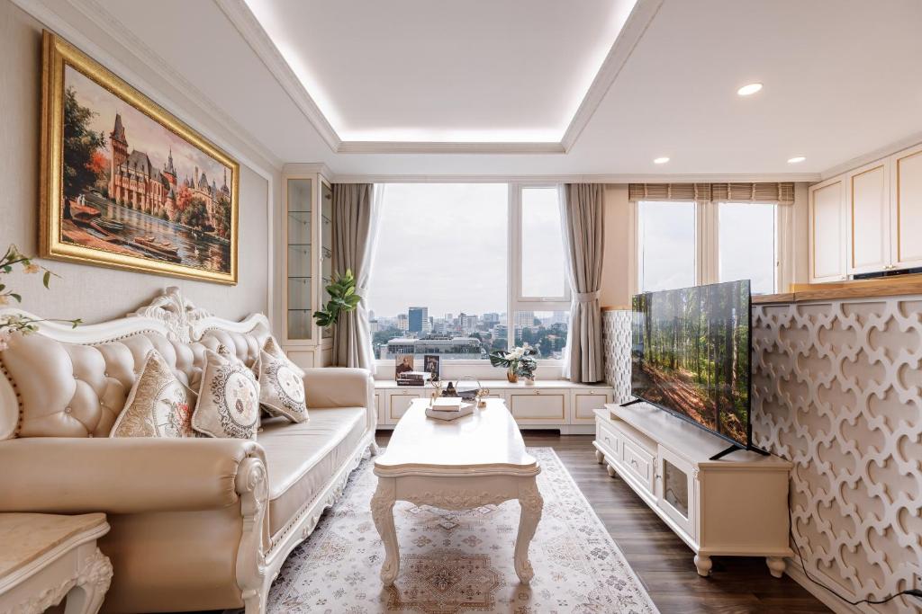 a living room with a couch and a large window at 2BR 3BR Luxury Apartment Sky Pool in Ho Chi Minh City