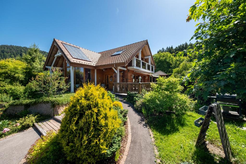 a wooden house with a pathway leading to it at Chalet Du Pont Des Fées in Gérardmer