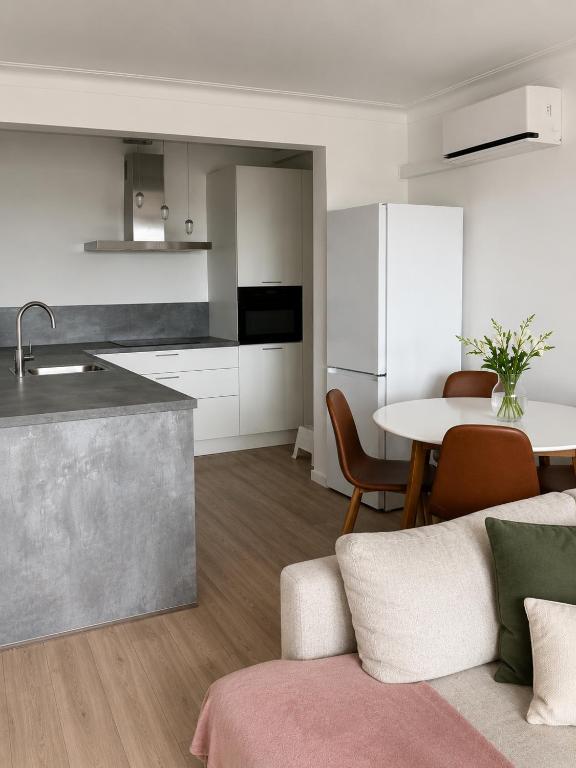 a kitchen and a living room with a table at The North Antwerp Apartment in Antwerp