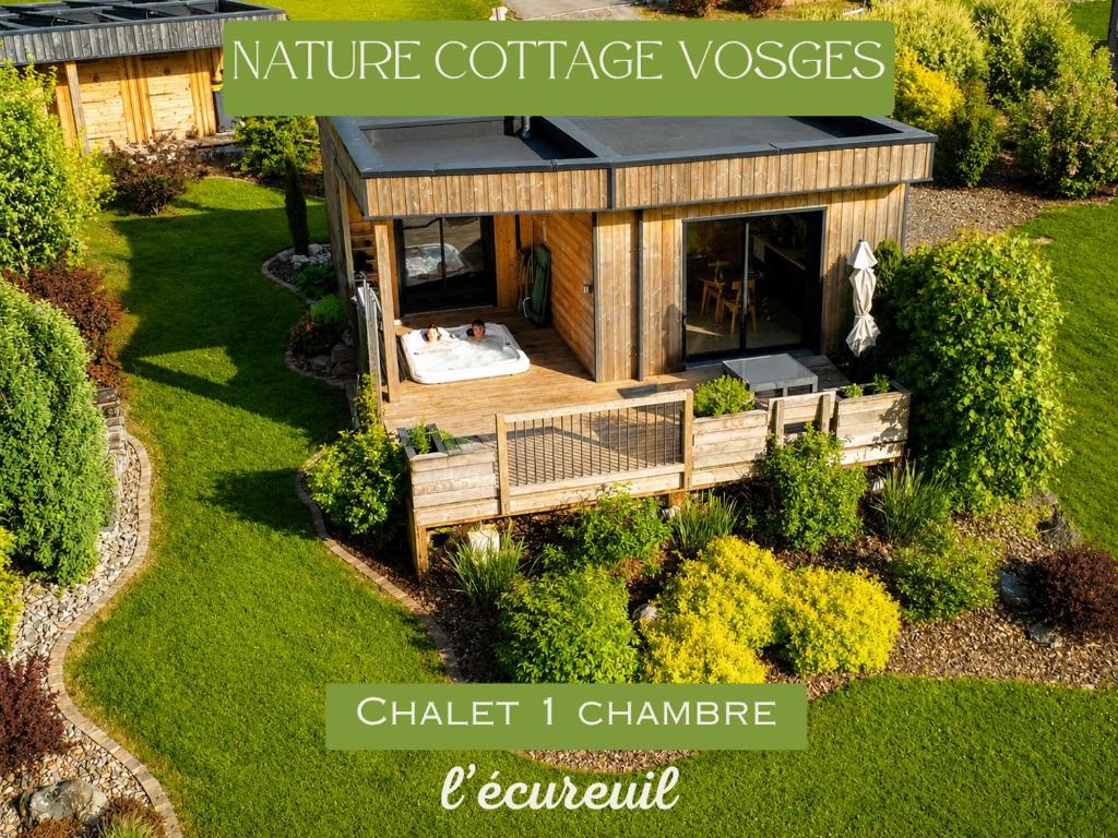a tiny house with a hot tub in a garden at Nature Cottage Vosges in Anould