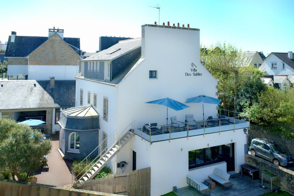 a white building with umbrellas on top of it at La Villa des Sables in Concarneau