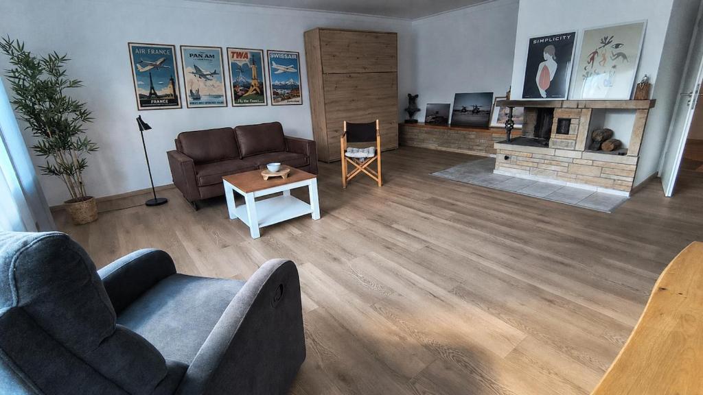 a living room with a couch and a fireplace at Living in Rheine in Rheine