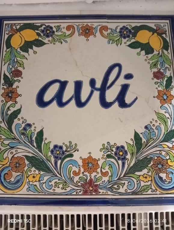a sign that says aleket with a floral pattern at Avli in Samothraki
