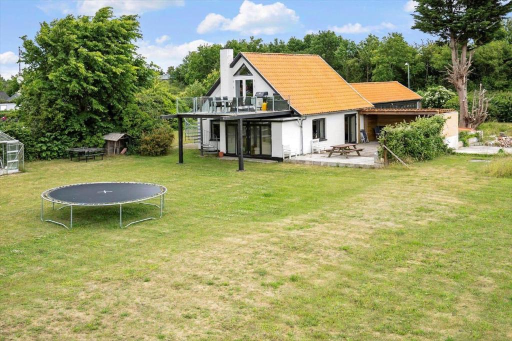 a house with a table in front of a yard at 4231-Stege-Nymarksvej-21 in Stege