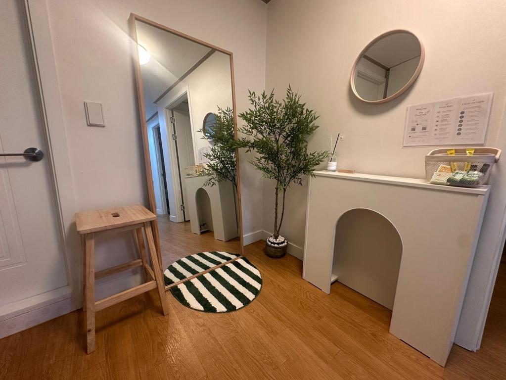 a room with a mirror and a table with a potted plant at The Greenery Omok in Seoul