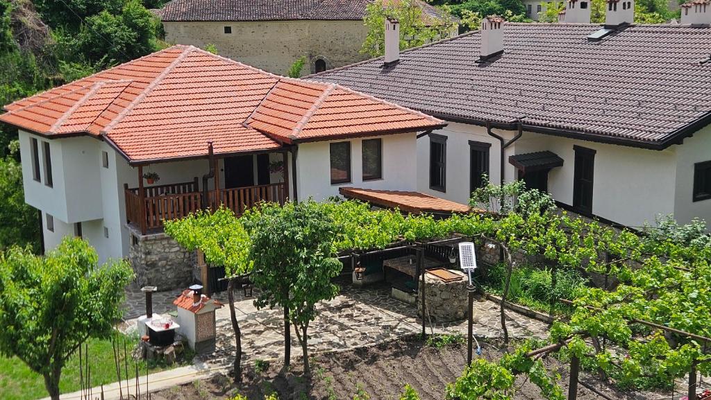 a house with red roofs and a bunch of trees at Dermendzhiev Apartments Melnik in Melnik
