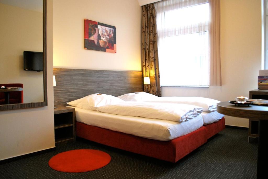 Postel nebo postele na pokoji v ubytování Hotel Dietrichsdorfer Hof