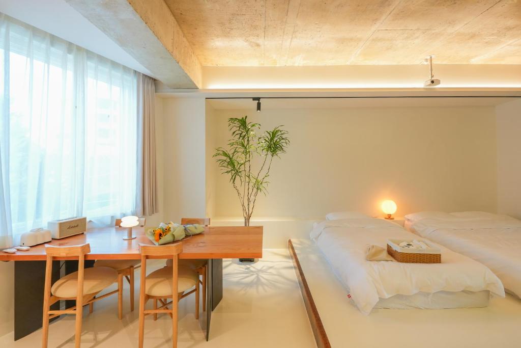 a bedroom with a bed and a desk and a table at 스테이머묾 m2 in Jeonju
