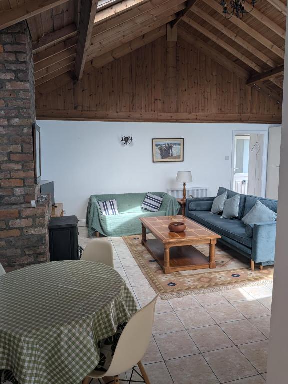a living room with a blue couch and a table at The Stables in Aglish