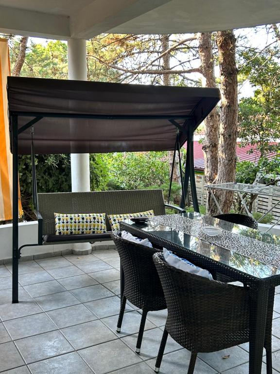 a patio with a table and chairs under a canopy at Apartments Peace&Love in Baška