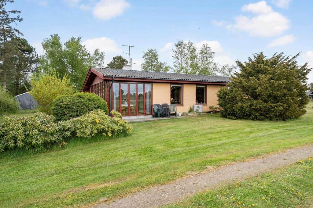 a small house in a field with a yard at 1039-Stege-Rylevej-30 in Stege