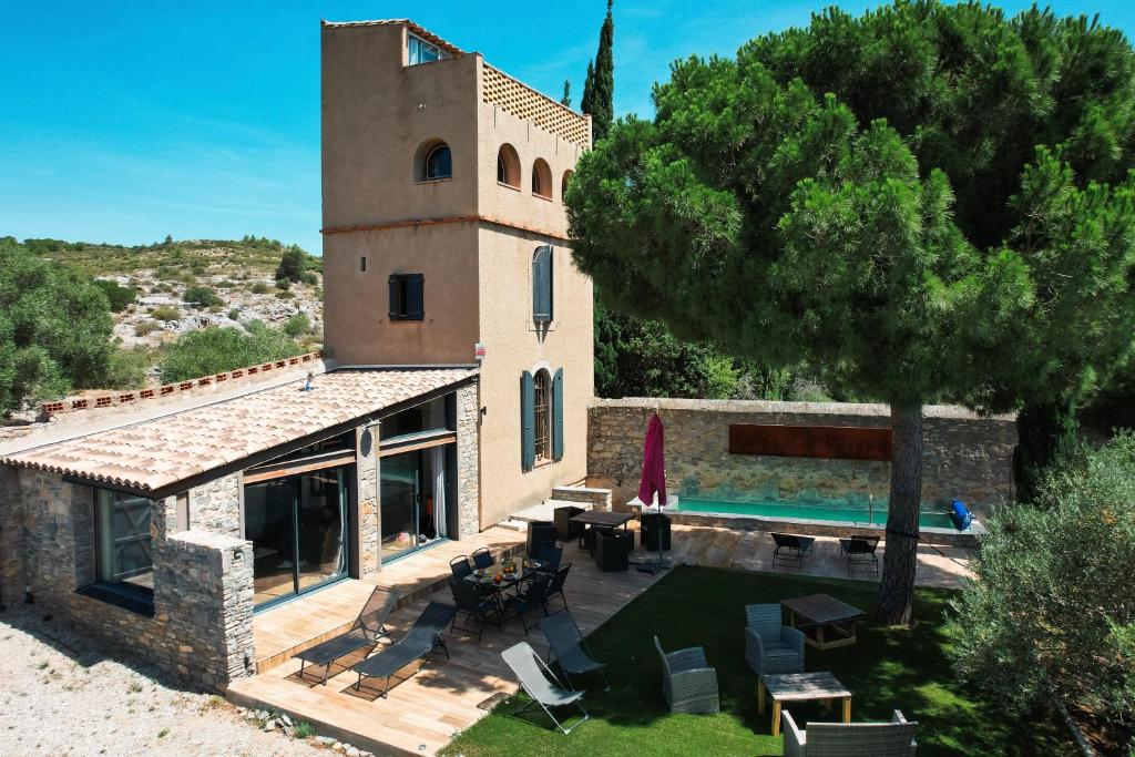 an external view of a house with a swimming pool at La Tour de La Palme in Lapalme
