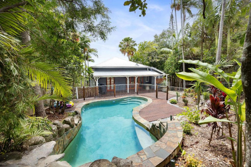 an image of a swimming pool in a garden at Pacific Terrace Beach House in Coolum Beach