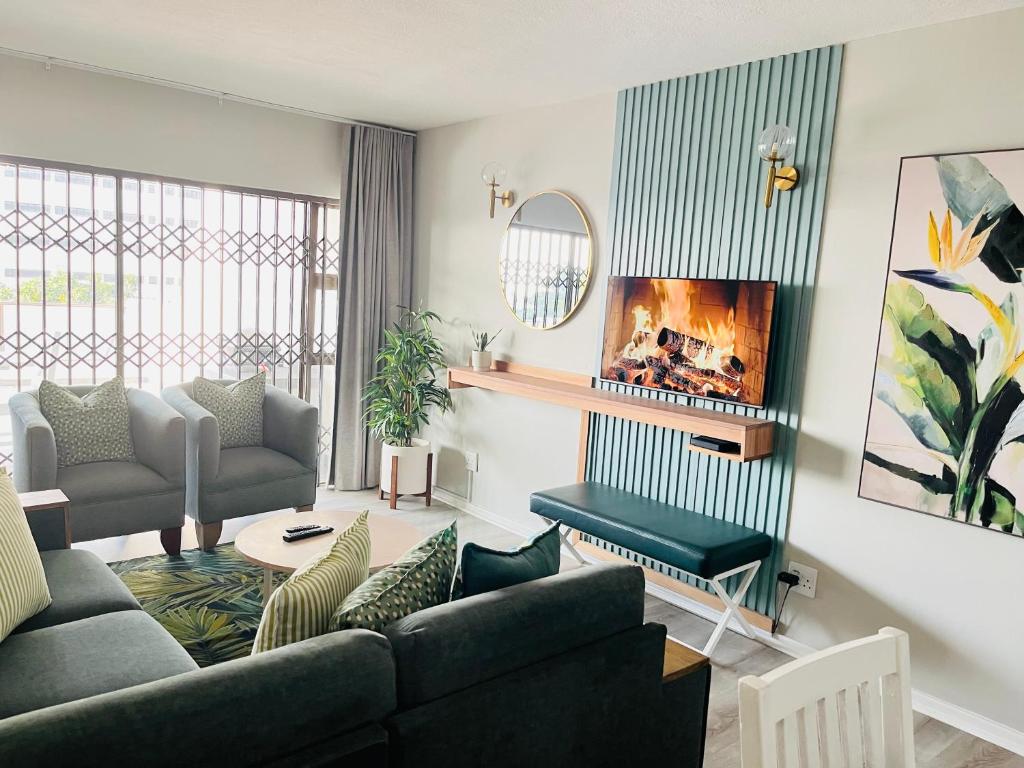 a living room with a couch and a table at Hyde Park in Durban