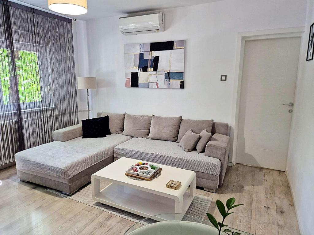 a living room with a couch and a coffee table at Apartman Franko - SELF CHECK IN in Osijek