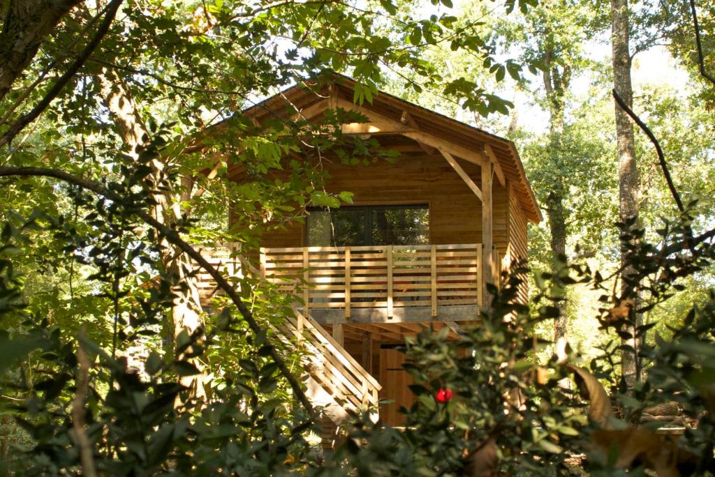 a wooden cabin in the middle of trees at Ecolodges de Loire & Spa in Gennes