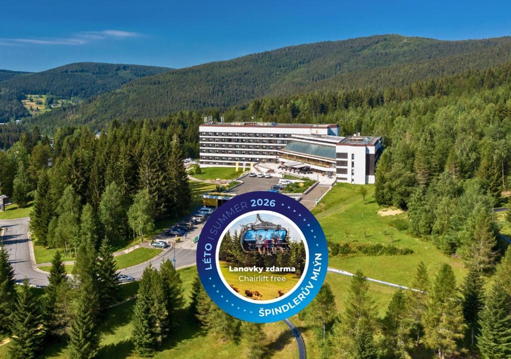 a sign in front of a building in the mountains at Harmony Hotel in Špindlerův Mlýn