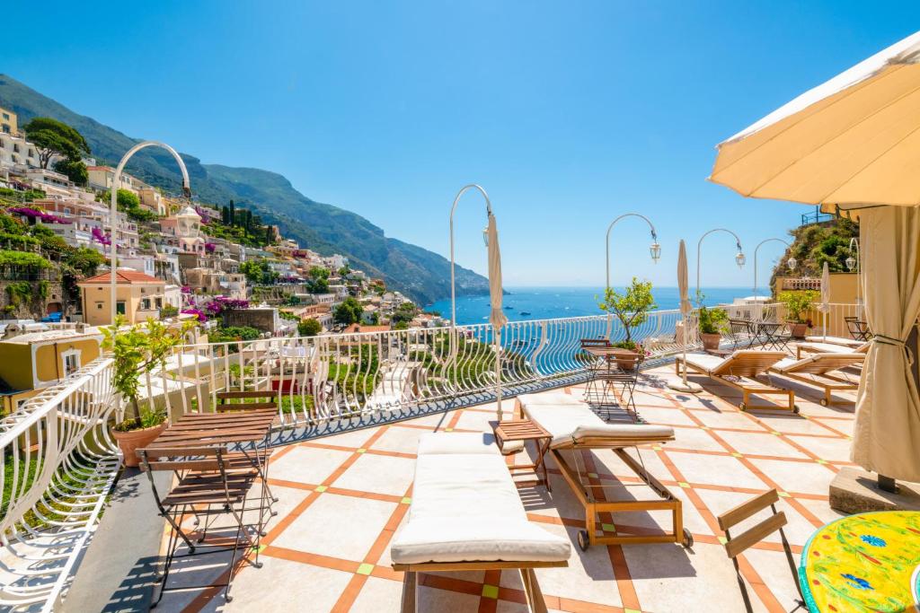 a view from the roof of a hotel with chairs and tables at Florida Residence in Positano