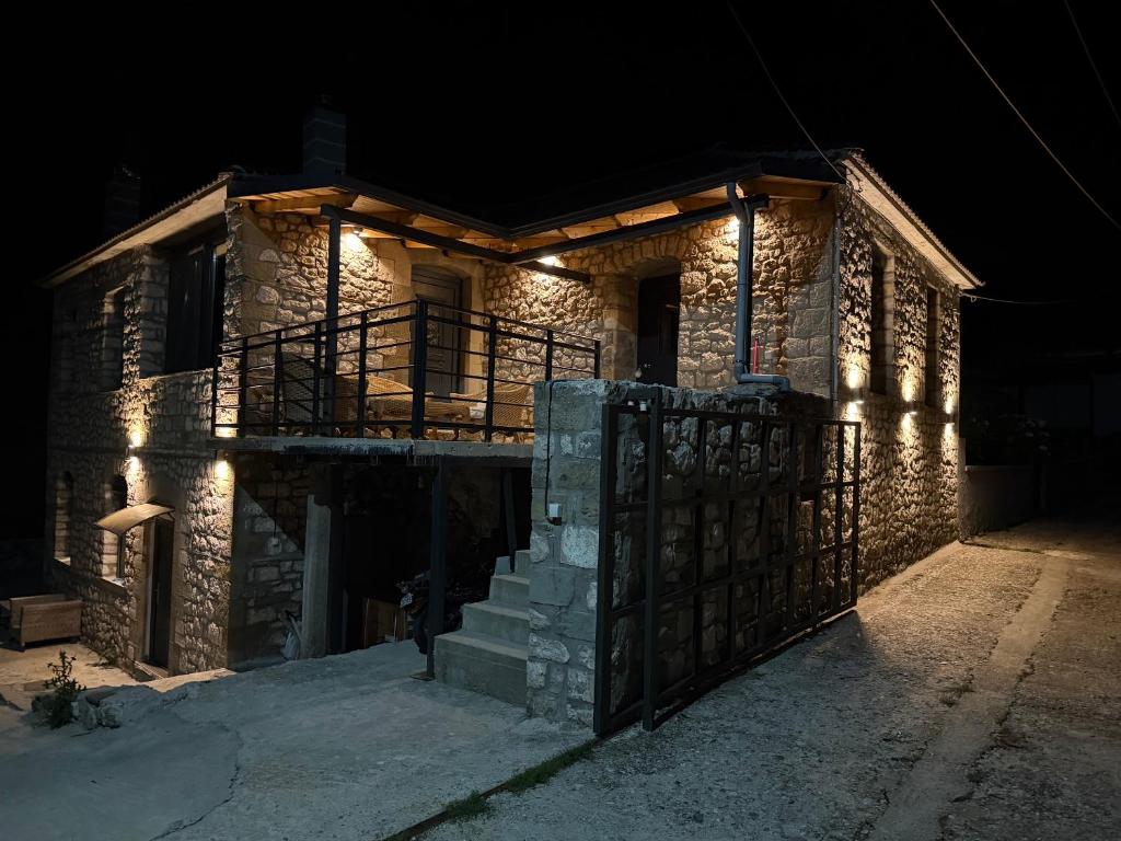 a stone house with lights on it at night at Vasiliki Pramanta villas in Pramanta