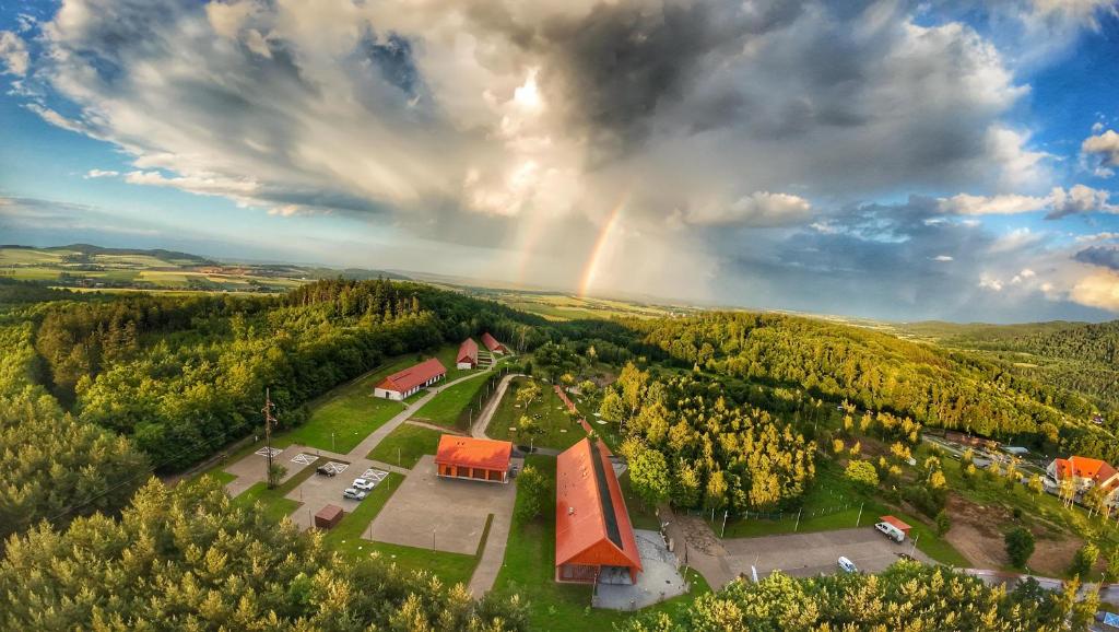 an aerial view of a farm with a rainbow in the sky at Bardo CAMP in Bardo