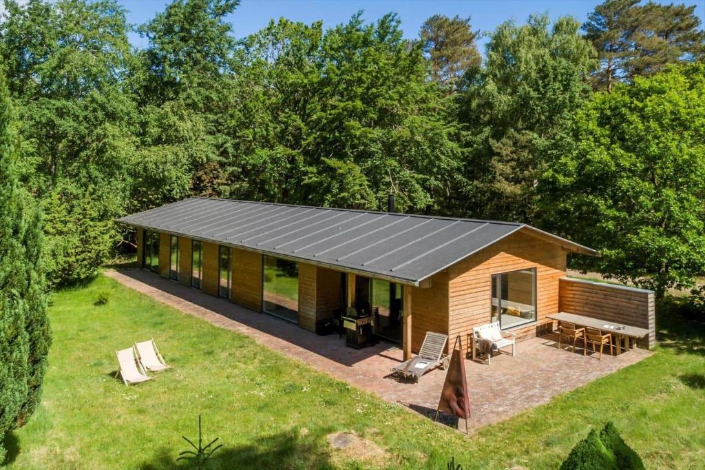 a house with a metal roof on a yard at 2314-Stege-Ulvshale-Cedervej-4-B in Tyrholm