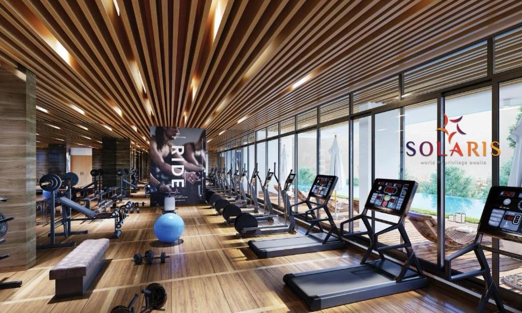 a gym with a row of treadmills and machines at Solaris in Christiansborg