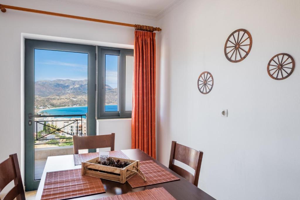 a dining room with a table and a large window at Fronis Studios in Karpathos
