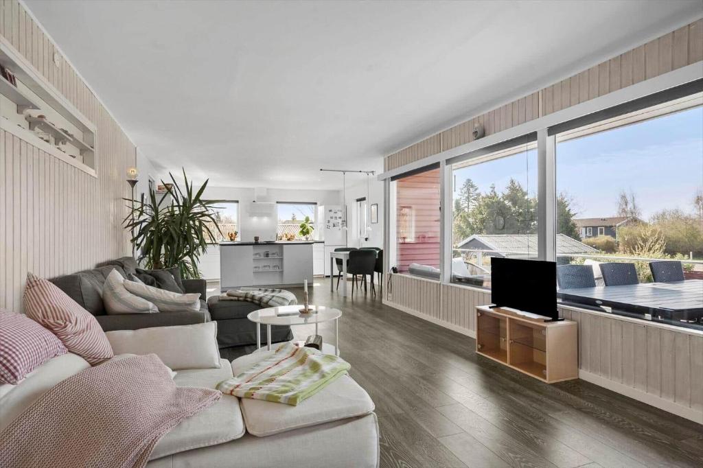 a living room with a couch and a tv in it at 8242-Vordingborg-Kvaedevej-8 in Bakkebølle Fredskov