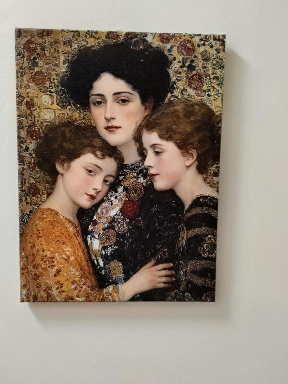 a painting of a woman and her three daughters at Cornerstone Budget in Ashford