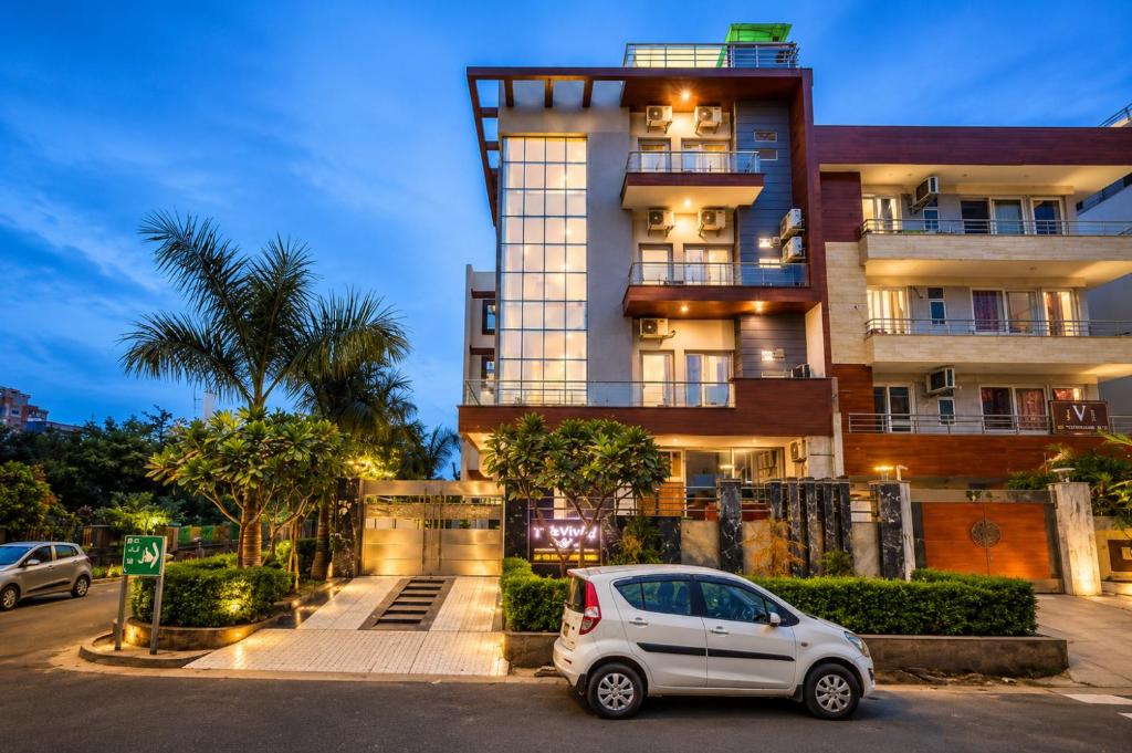 a white car parked in front of a building at Hotel Vibe Blue Sec 70, Near Kailash Hospital & Sec 61 -52 Metro in Noida
