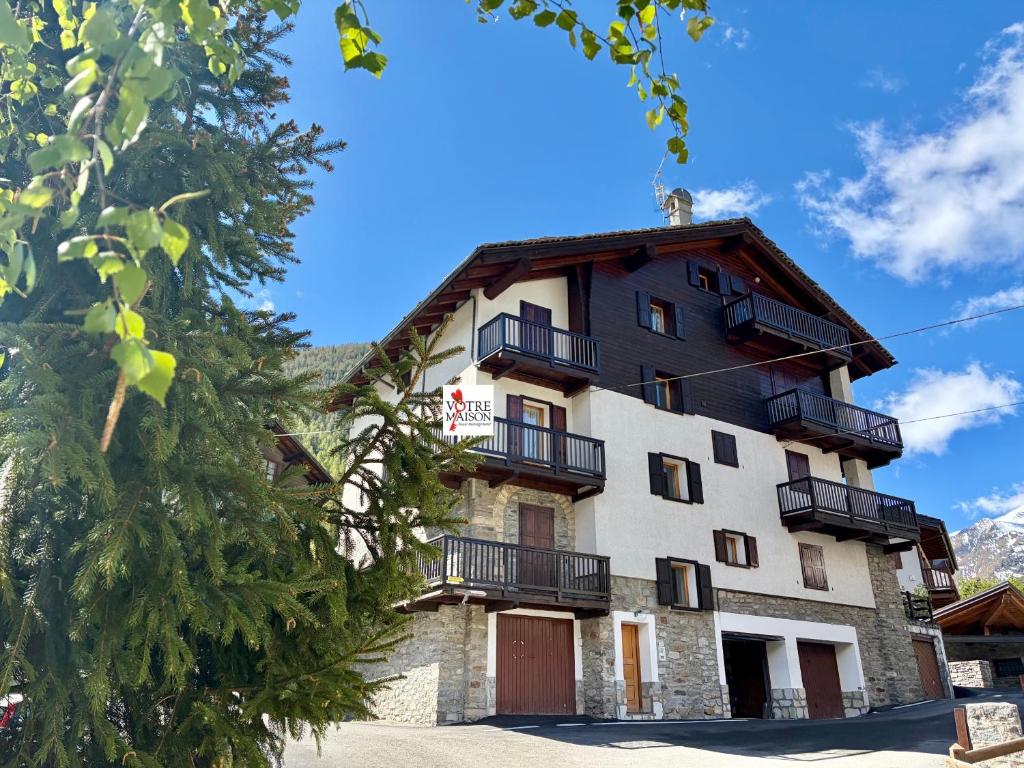 a building with balconies on the side of it at Borealis - VOTRE MAISON in Cogne