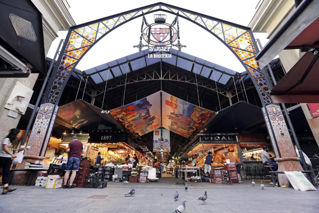 a market with pigeons standing in the middle of a building at Arc La Rambla in Barcelona