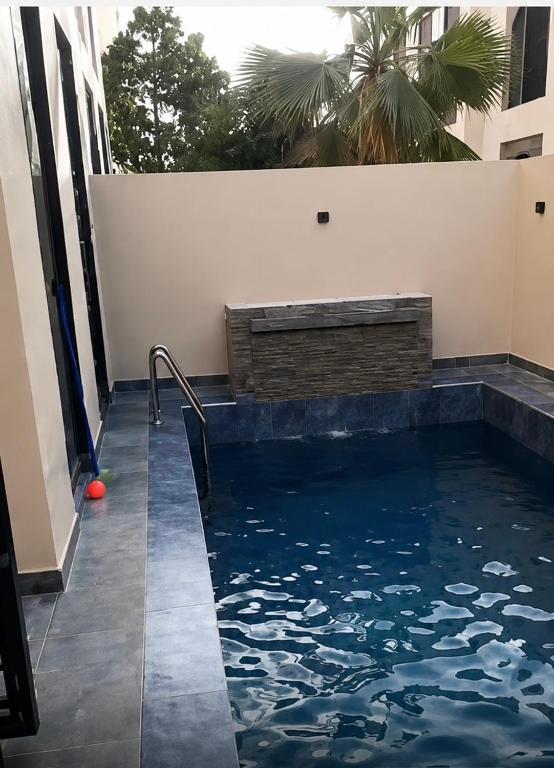 a swimming pool with a red ball in the water at Les 3 perles in Ras El Ma