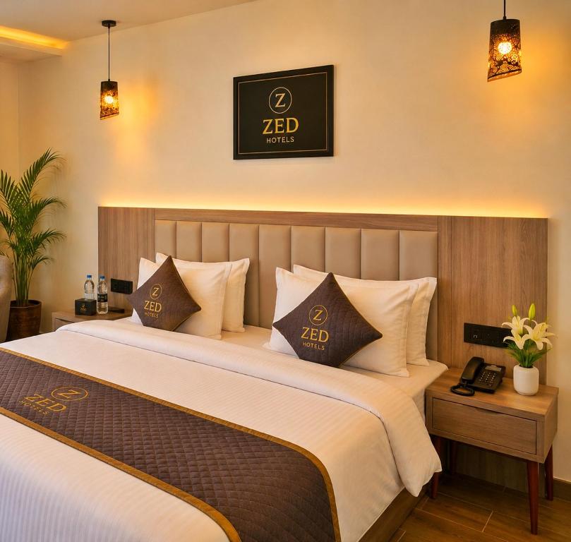a hotel room with two beds and a sign on the wall at ZED Plaza in New Delhi