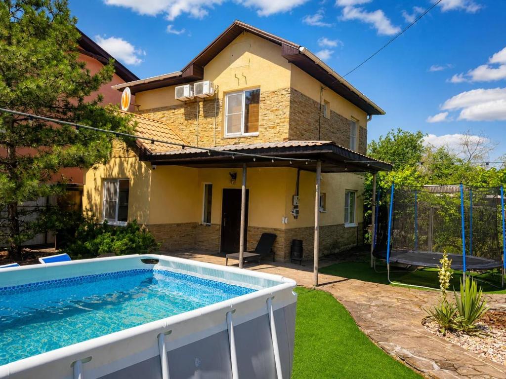a house with a swimming pool in a yard at Sunny House Seaside in Zatoka