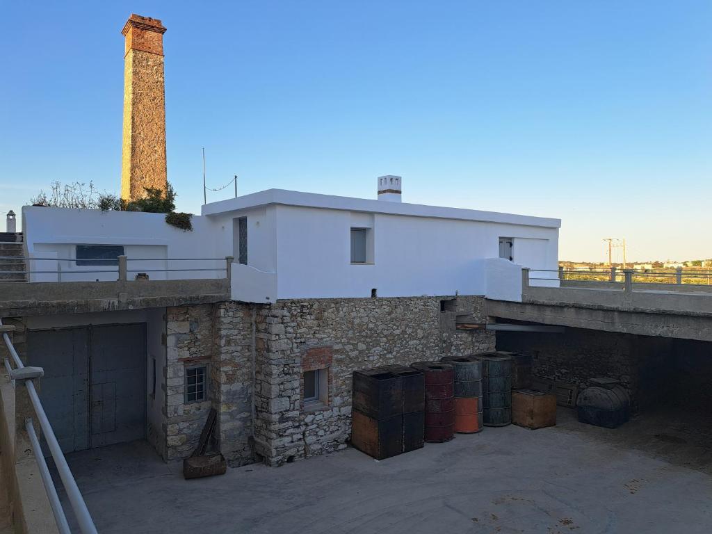 a building with a tower on top of it at Olive Mill Complex in Livadi